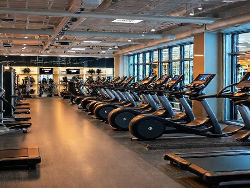 A sculptural, minimalist representation of an award trophy or badge. It's sleek, angular, and made of polished dark chrome, with subtle internal lighting in electric blue or a soft, metallic glow emanating from its core. The design is abstract, focusing on form and light, conveying prestige and excellence without being a specific, recognizable trophy.